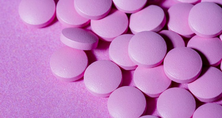 high-angle-pills-on-purple-background